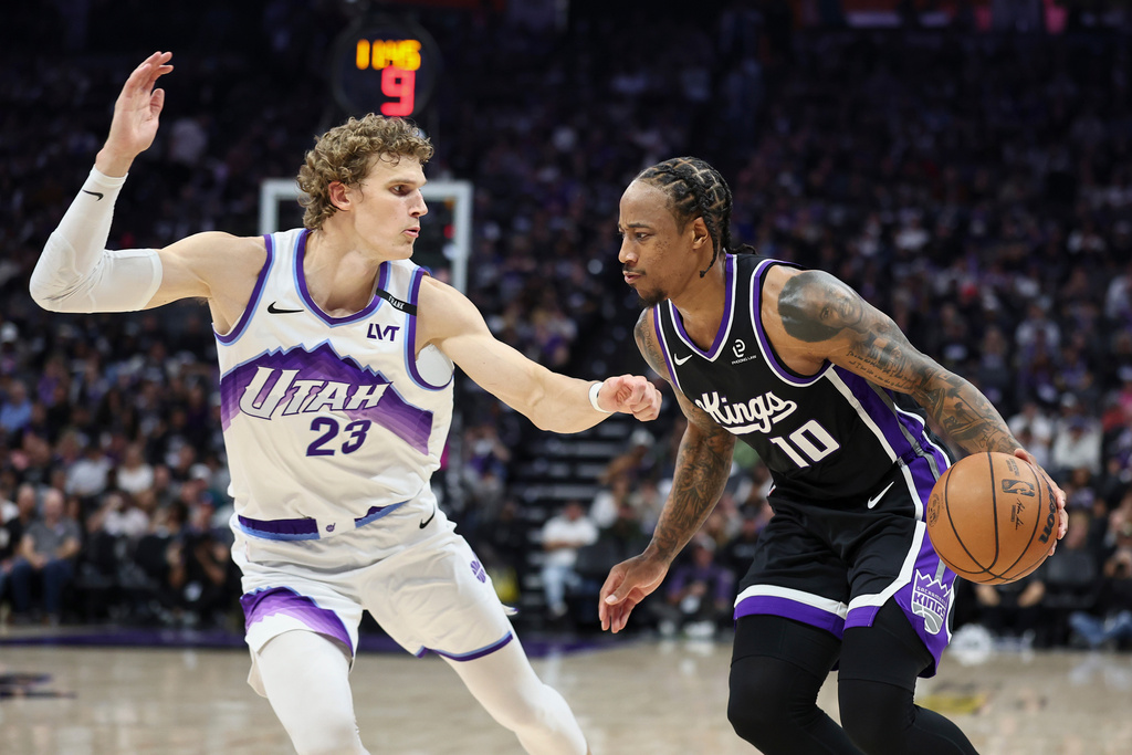 Sacramento Kings guard Demar Derozan (10) drives to the basket with Utah Jazz forward Lauri Markkanen (23) defending during the first half of an NBA basketball game Friday, Oct. 24, 2025, in Sacramento, Calif. (AP Photo/Sara Nevis)