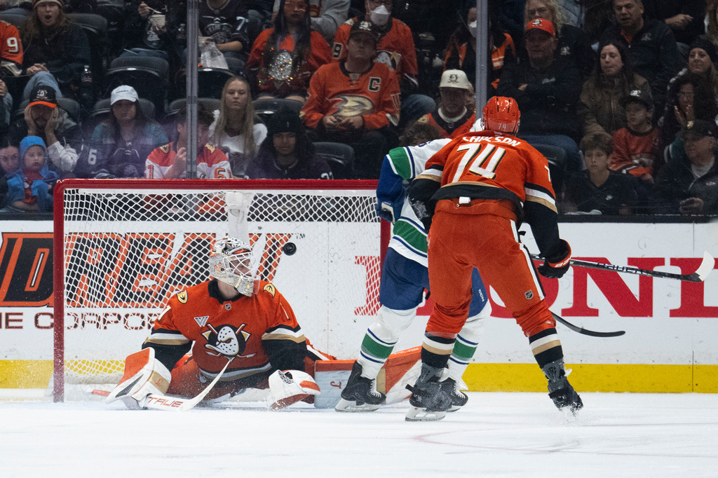 The shot by Vancouver Canucks right wing Brock Boeser goes past Anaheim Ducks goaltender Lukas Dostal, left, during the third period of an NHL hockey game, Sunday, April 12, 2026, in Anaheim, Calif. (AP Photo/Kyusung Gong)