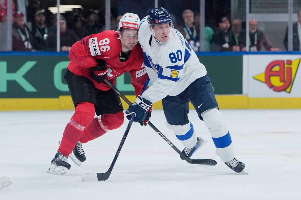Finland's Saku Maenalanen (80) in action against Switzerland's Janis Moser (86) during the 2026 IIHF Men's Ice Hockey World Championship final match between Switzerland and Finland, in Zurich, Switzerland, Sunday, May 31, 2026. (AP Photo/Darko Bandic)