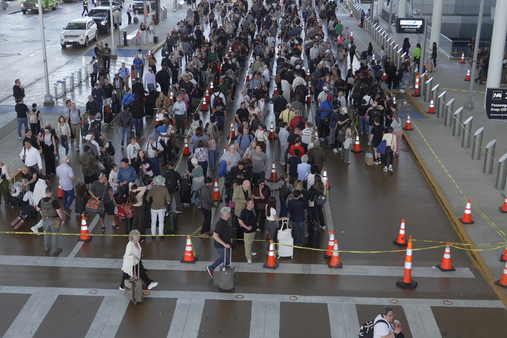 Travelers line up at a TSA checkpoint at George Bush Intercontinental Airport in Houston, Thursday, March 26, 2026. (AP Photo/Lekan Oyekanmi)