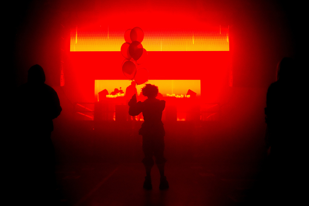 A man dressed as Pennywise dances during a Halloween rave in Kyiv, Ukraine, Saturday, Oct. 25, 2025. (AP Photo/Julia Demaree Nikhinson)