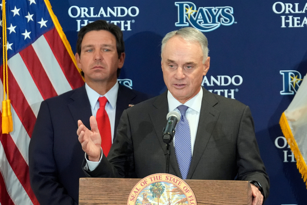 Major League Baseball commissioner Rob Manfred, right, gestures during a new baseball stadium news conference as Florida Gov. Ron DeSantis looks, Tuesday, Feb. 3, 2026, at Hillsborough College in Tampa, Fla. (AP Photo/Chris O'Meara)