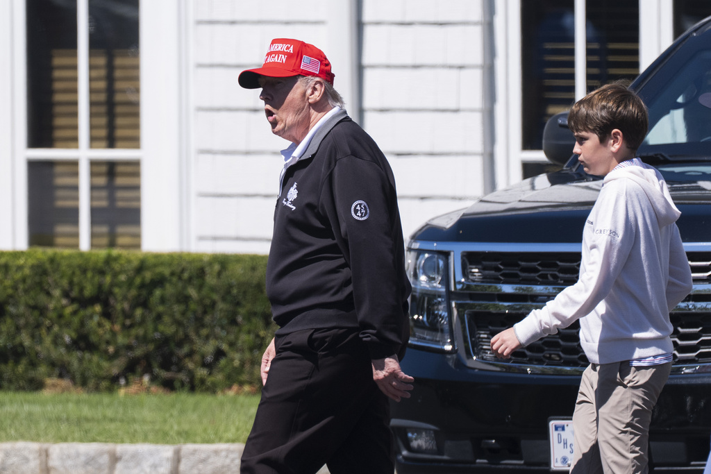 President Donald Trump, left, walks with his grandson Spencer Trump at the Trump National Golf Club in Sterling, Va., Saturday, Aug. 30, 2025. (AP Photo/Manuel Balce Ceneta)