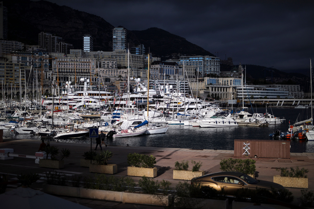 FILE - A luxury car drives along Monaco Harbor, Nov. 19, 2020. (AP Photo/Daniel Cole, File)