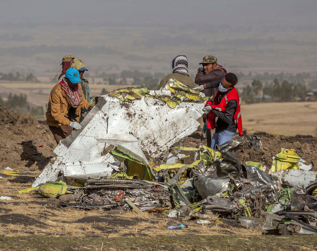 FILE - In this March 11, 2019, file photo, rescuers work at the scene of an Ethiopian Airlines flight crash near Bishoftu, Ethiopia. Pilot Bernd Kai von Hoesslin pleaded with his bosses for more training on the Boeing Max, just weeks before the Ethiopian Airline's jet crashed, killing everyone on board. (AP Photo/Mulugeta Ayene, File)