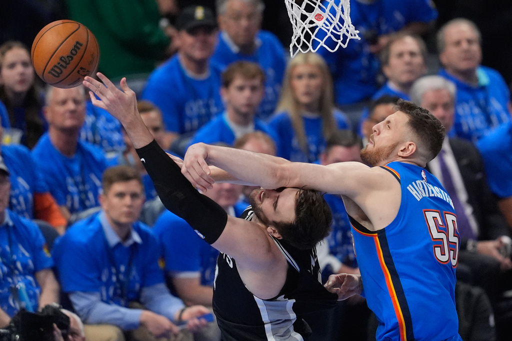 Oklahoma City Thunder center Isaiah Hartenstein (55) blocks a shot by San Antonio Spurs center Luke Kornet (7) during the first half of Game 1 in a third-round NBA basketball playoffs series Monday, May 18, 2026, in Oklahoma City. (AP Photo/Tony Gutierrez)