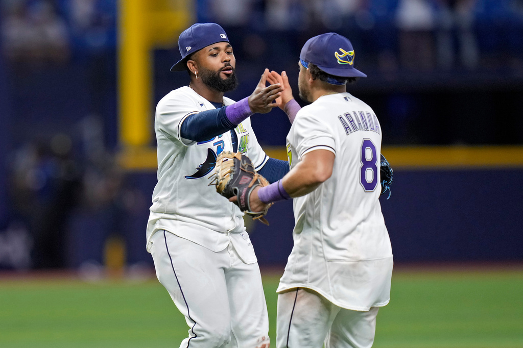 Tampa Bay Rays third baseman Junior Caminero celebrates with first baseman Jonathan Aranda (8) after the team defeated the New York Yankees during a baseball game Friday, April 10, 2026, in St. Petersburg, Fla. (AP Photo/Chris O'Meara)