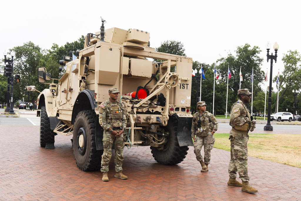 Members of the District of Columbia National Guard, stand next to an M-ATV infantry mobility vehicle, outside the Union Station in Washington, Monday, Aug. 18, 2025. (AP Photo/Manuel Balce Ceneta)