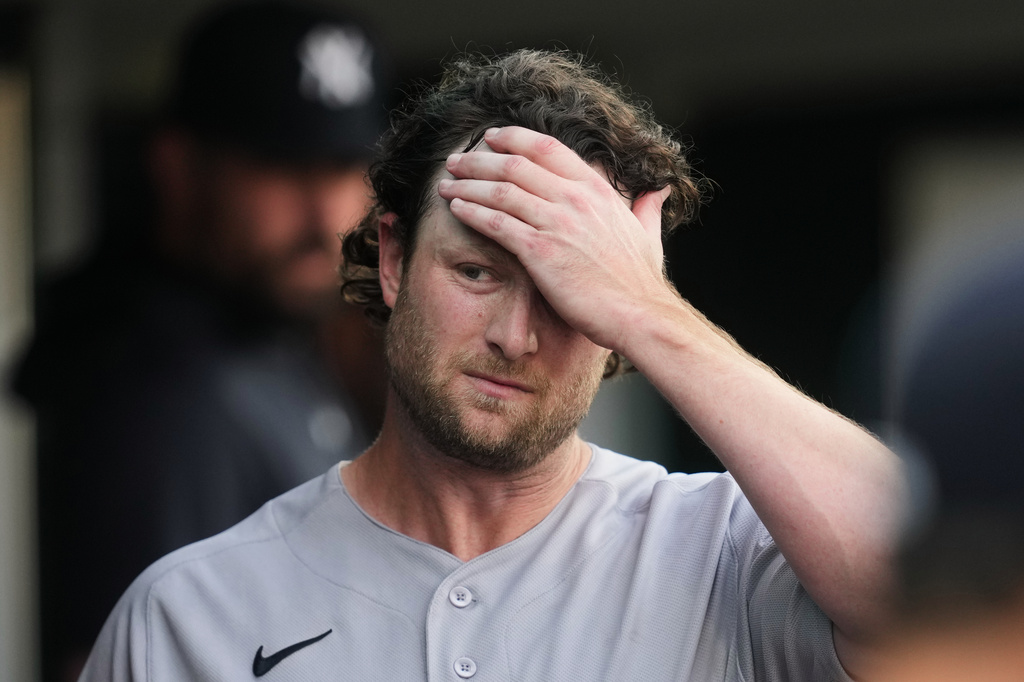 New York Yankees pitcher Gerrit Cole walks in the dugout against the Detroit Tigers during the fifth inning of a baseball game Monday, June 22, 2026, in Detroit. (AP Photo/Paul Sancya)