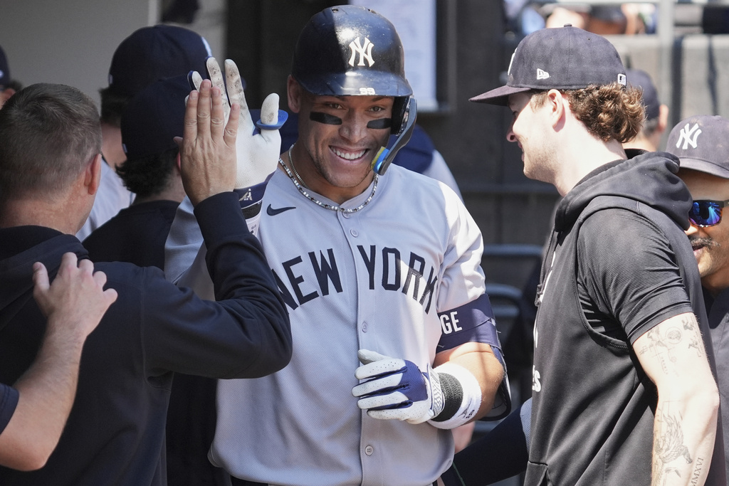 New York Yankees' Aaron Judge celebrates with teammates after hitting a solo home run during the first inning of a baseball game against the Chicago White Sox in Chicago, Sunday, Aug. 31, 2025. (AP Photo/Nam Y. Huh)