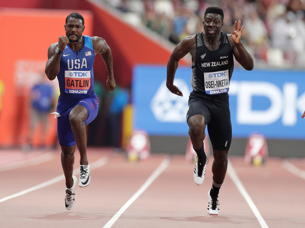 FILE - New Zealand's Edward Osei-Nketia, right, and Justin Gatlin, of the United States, compete in the men's 100 meters heat at the World Athletics Championships in Doha, Qatar, Sept. 27, 2019. (AP Photo/Petr David Josek, File)