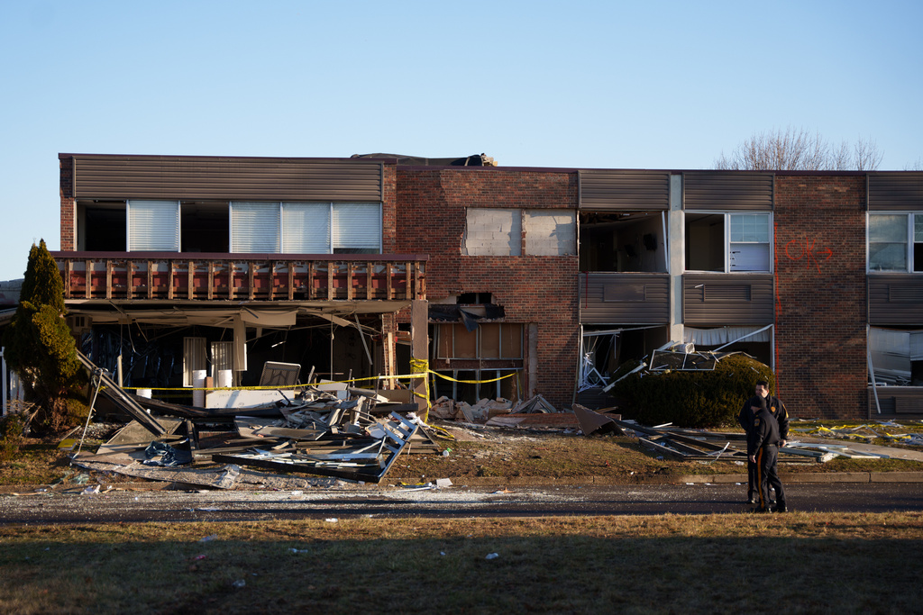 Investigators work around Bristol Health & Rehab Center and surrounding rubble after a gas explosion the day prior on Wednesday, Dec. 24, 2025, in Bristol, Pa. (AP Photo/Mingson Lau)