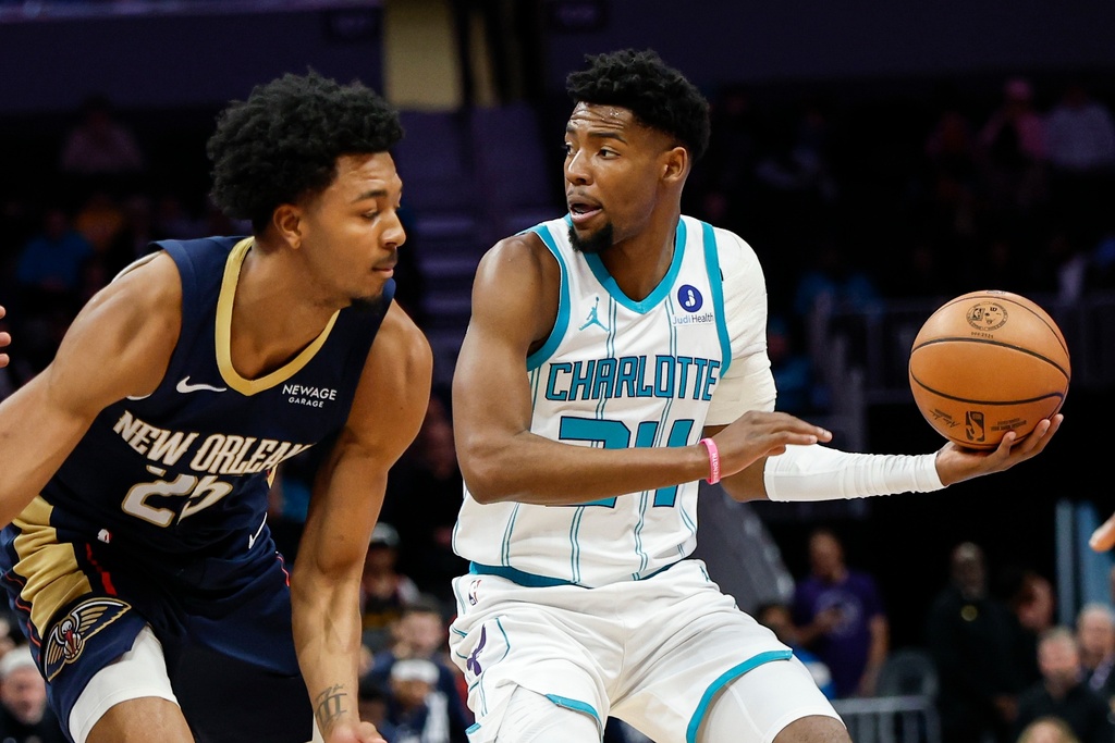 Charlotte Hornets forward Brandon Miller, right, looks to pass the ball against New Orleans Pelicans forward Trey Murphy III, left, during the first half of an NBA basketball game in Charlotte, N.C., Monday, Feb. 2, 2026. (AP Photo/Nell Redmond)