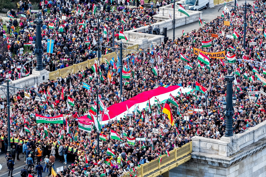 In this photo taken by a drone, participants of the Peace March organized by the pro-government Civil Unity Forum (COF) and its foundation Civil Unity Public Benefit Foundation (COKA) gather at the Buda side of Margaret Bridge in Budapest, Hungary, Thursday, Oct. 23, 2025, on the 69th anniversary of the Hungarian revolution and war of independence against communist rule and the Soviet Union in 1956. (Zsolt Czegledi/MTI via AP)