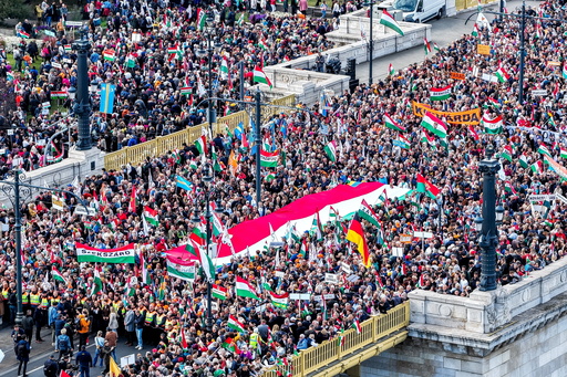 In this photo taken by a drone, participants of the Peace March organized by the pro-government Civil Unity Forum (COF) and its foundation Civil Unity Public Benefit Foundation (COKA) gather at the Buda side of Margaret Bridge in Budapest, Hungary, Thursday, Oct. 23, 2025, on the 69th anniversary of the Hungarian revolution and war of independence against communist rule and the Soviet Union in 1956. (Zsolt Czegledi/MTI via AP) In this photo taken by a drone, participants of the Peace March organized by the pro-government Civil Unity Forum (COF) and its foundation Civil Unity Public Benefit Foundation (COKA) gather at the Buda side of Margaret Bridge in Budapest, Hungary, Thursday, Oct. 23, 2025, on the 69th anniversary of the Hungarian revolution and war of independence against communist rule and the Soviet Union in 1956. (Zsolt Czegledi/MTI via AP)