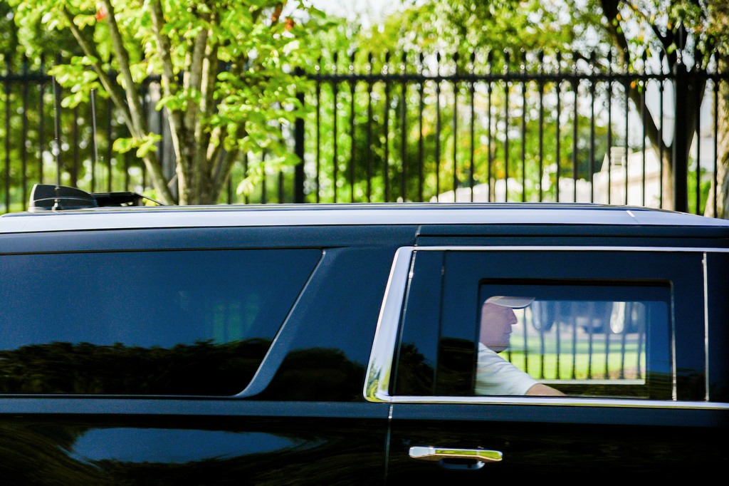President Donald Trump sits in the back seat of the presidential SUV as he departs the White House en route to Trump National Golf Club, Saturday, Aug. 29, 2026, in Sterling, Va. (AP Photo/Julia Demaree Nikhinson)