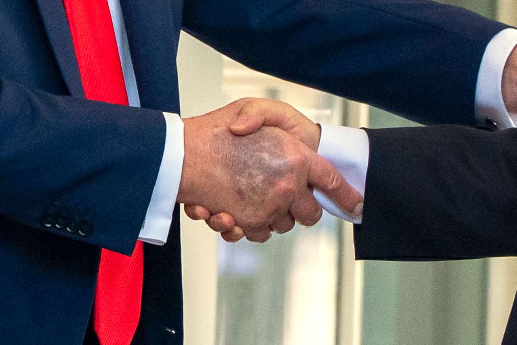 President Donald Trump, left, shakes hands with South Korean President Lee Jae Myung upon his arrival at the White House, Monday, Aug. 25, 2025, in Washington. (AP Photo/Alex Brandon)