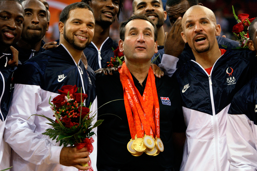 FILE - USA's coach Mike Krzyzewski, center, flanked by Deron Williams, left, and Jason Kidd, right, wears his players gold medals as they celebrate after beating Spain in the men's gold medal basketball game at the 2008 Olympics in Beijing, Aug. 24, 2008. (AP Photo/Dusan Vranic, File)