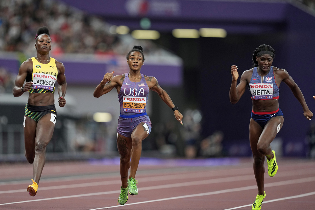 United States' Sha'Carri Richardson, Britain's Daryll Neita and Jamaica's Shericka Jackson compete in a women's 100 meters semifinal at the World Athletics Championships in Tokyo, Sunday, Sept. 14, 2025. (AP Photo/Petr David Josek)