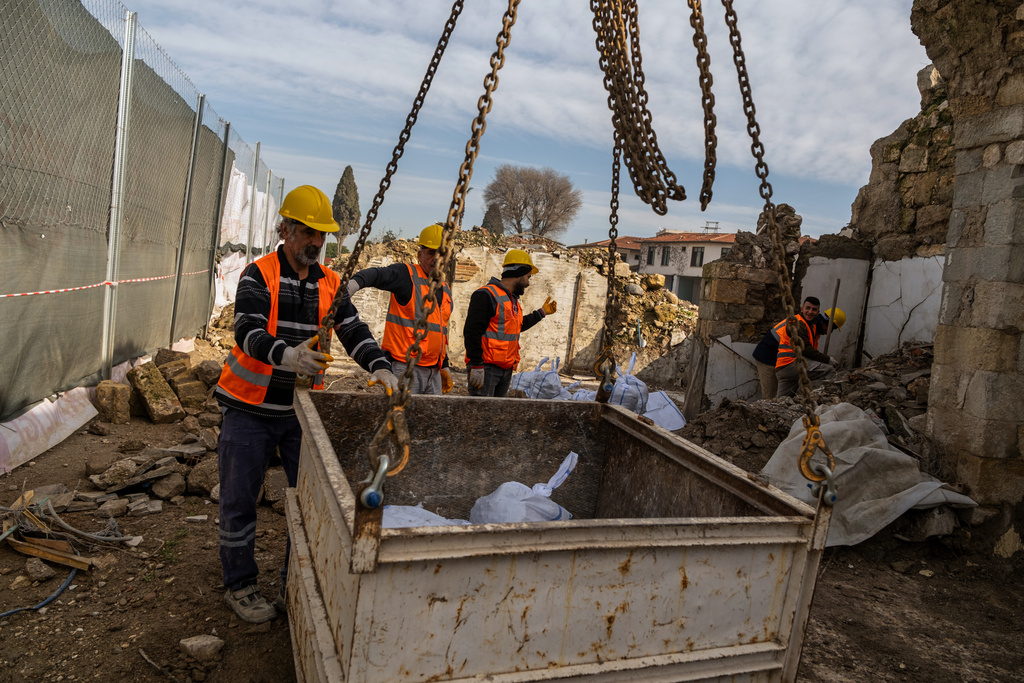 Workers clear rubble and salvage stones from the ruins of St. Paul's Greek Orthodox Church, damaged in the 2023 earthquake, in the city of Antakya, southern Turkey, Wednesday, Feb. 4, 2026. (AP Photo/Murat Kocabas)