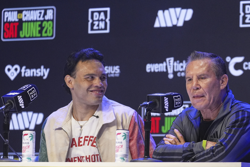 FILE - Boxers Cesar Chavez Jr,, left, smiles towards his father Julio Cesar Chavez, Mexico's former world champion, during a boxing news conference at the Avalon Hollywood Theatre in Los Angeles, May 14, 2025. (AP Photo/Damian Dovarganes, File)