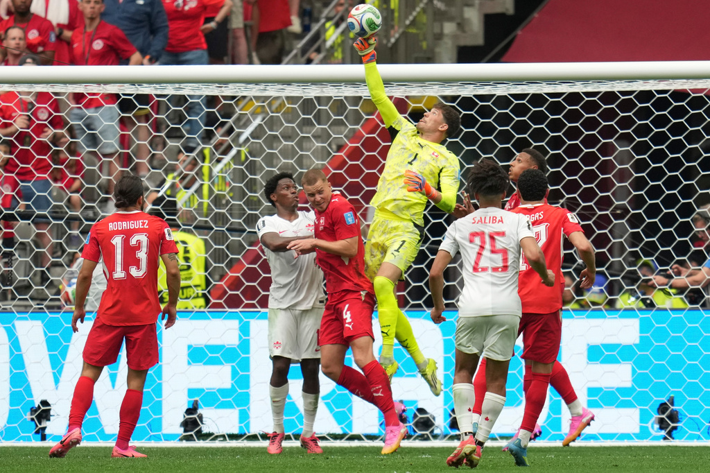 Switzerland goalkeeper Gregor Kobel (1) jumps to make a save during the World Cup Group B soccer match between Switzerland and Canada in Vancouver, British Columbia, Wednesday, June 24, 2026. (AP Photo/Abbie Parr)
