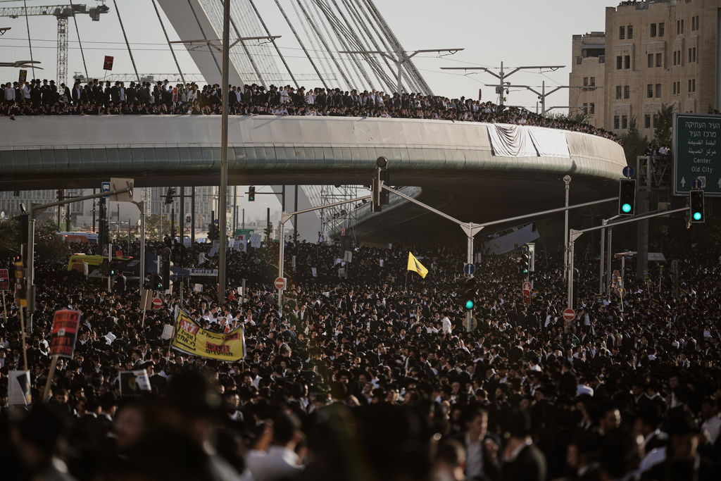 Ultra-Orthodox Jewish men attend a rally against plans to force them to serve in the Israeli military, in Jerusalem, Thursday, Oct. 30, 2025. (AP Photo/Leo Correa)