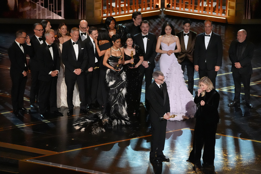 Paul Thomas Anderson, left center, Sara Murphy, right center, and the team from "One Battle After Another" accept the award for best picture during the Oscars on Sunday, March 15, 2026, at the Dolby Theatre in Los Angeles. (AP Photo/Chris Pizzello)