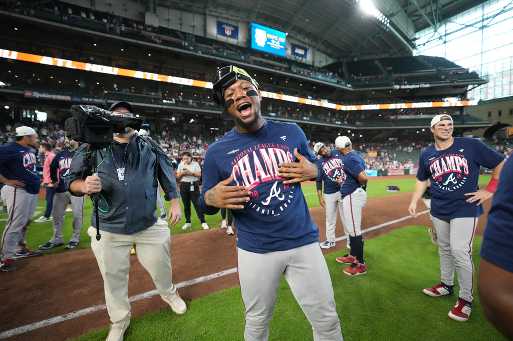 Atlanta Braves' Ronald Acuna Jr., center, celebrates on the field after a baseball game against the Houston Astros as the Braves clinched the NL East title, Sunday, Sept. 20, 2026, in Houston. (AP Photo/Karen Warren)