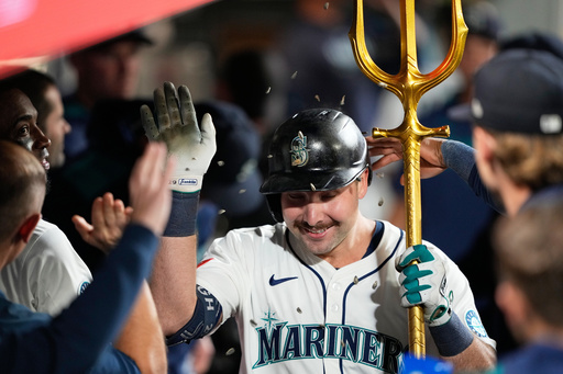 Seattle Mariners' Cal Raleigh celebrates in the dugout after hitting his 60th home run during the eighth inning of a baseball game against the Colorado Rockies, Wednesday, Sept. 24, 2025, in Seattle. (AP Photo/Ryan Sun) Seattle Mariners' Cal Raleigh celebrates in the dugout after hitting his 60th home run during the eighth inning of a baseball game against the Colorado Rockies, Wednesday, Sept. 24, 2025, in Seattle. (AP Photo/Ryan Sun)
