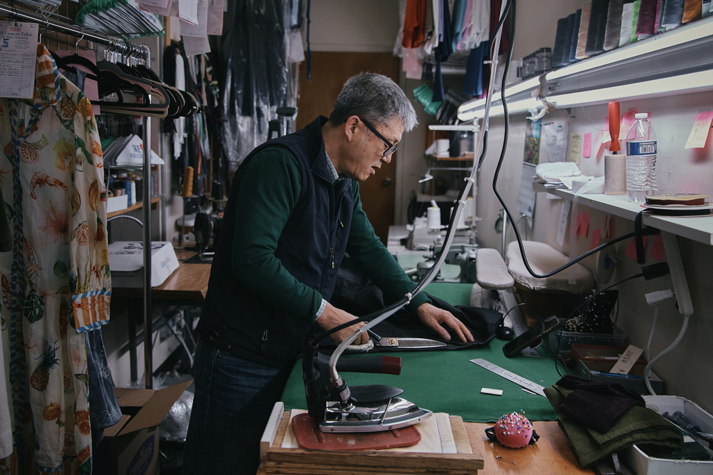 Tailor, Kil Bae, works inside his shop on Friday, March 27, 2026, in New York. (AP Photo/Andres Kudacki)