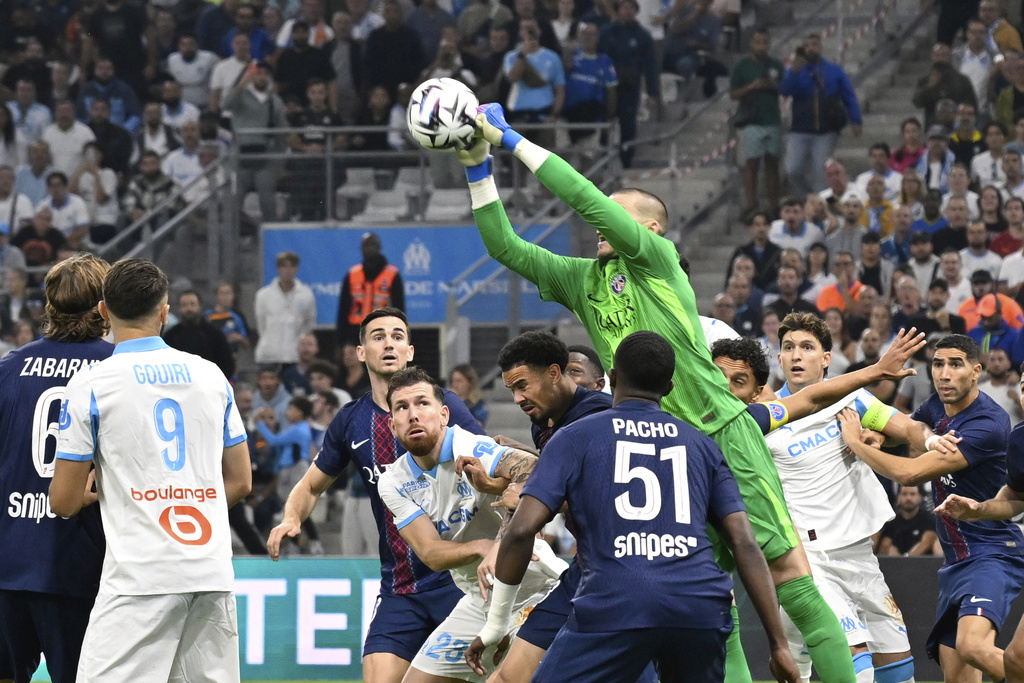 PSG's goalkeeper Lucas Chevalier makes a save during the French League One soccer match between Marseille and Paris Saint-Germain at Orange Velodrome in Marseille, France, Monday, Sept. 22, 2025. (AP Photo/Philippe Magoni)