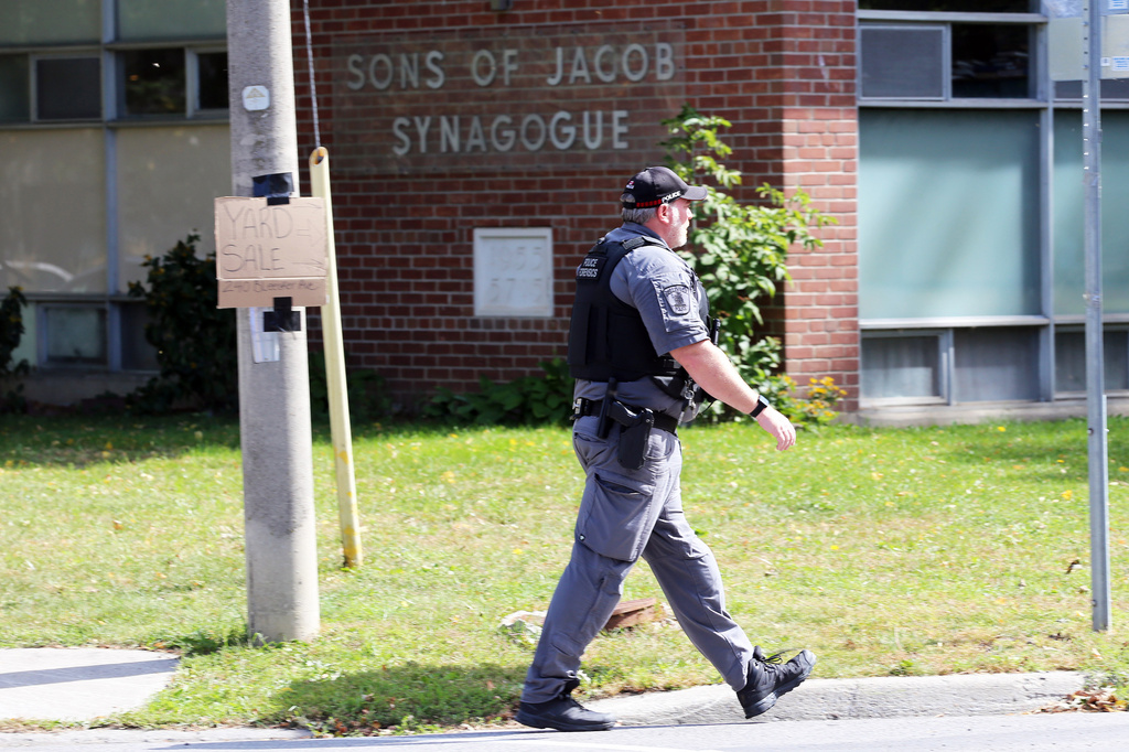 A police officer walks in front of the Son of Jacob Synagogue in Belleville, Ontario on Monday Sept. 21, 2026. (Ian MacAlpine/The Canadian Press via AP)