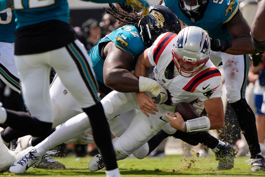 Jacksonville Jaguars defensive tackle Davon Hamilton (52) tackles New England Patriots quarterback Drake Maye (10) in the first half during an NFL football game in Jacksonville, Fla., Sunday, Sept. 27, 2026. (AP Photo/Mike Stewart)