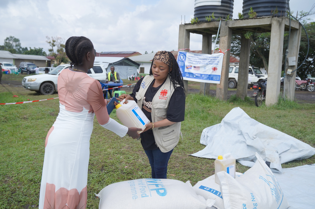 A woman collects a food donation from the World Food Programme at the Rwampara Ebola treatment center in Ituri, eastern Congo, Wednesday, July 29, 2026. (AP Photo/Dieudonne Dirole)