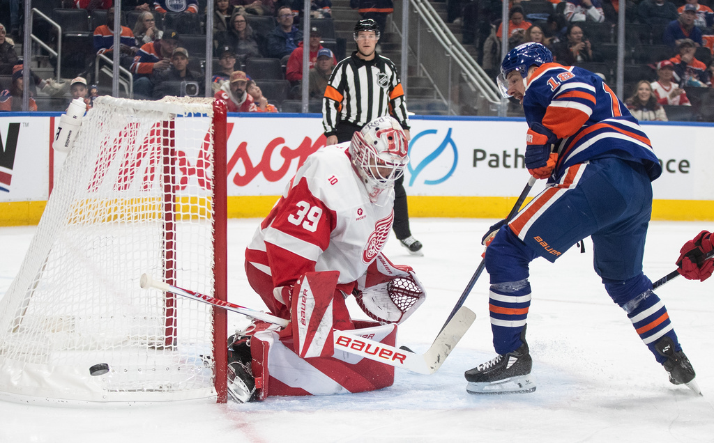 Detroit Red Wings goalie Cam Talbot (39) makes the save on Edmonton Oilers' Zach Hyman (18) during the second period of an NHL game, in Edmonton on Thursday, Dec. 11, 2025. (Jason Franson/The Canadian Press via AP)