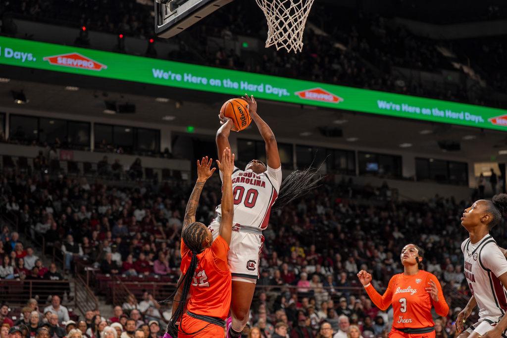 South Carolina guard Ta'Niya Latson (00) goes up to shoot over Bowling Green guard Ky'Aira Miller (12) during the first half of an NCAA college basketball game Friday, Nov. 7, 2025, in Columbia, S.C. (AP Photo/David Yeazell)