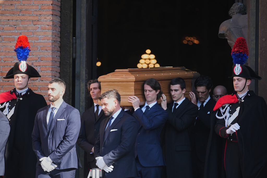 The casket of fashion designer Valentino Garavani leaves the St. Mary of Angels Basilica at the end of his funeral, in Rome, Friday, Jan. 23, 2026. (AP Photo/Andrew Medichini)