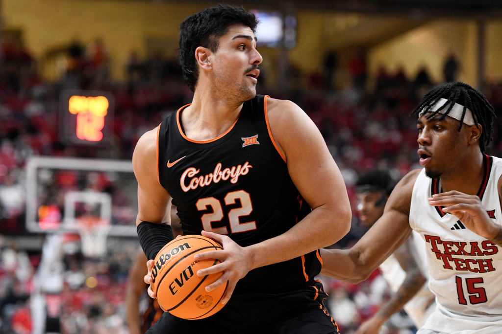 Oklahoma State center Parsa Fallah (22) looks to pass the ball during the second half in an NCAA college basketball game against Texas Tech, Saturday, Jan. 3, 2026, in Lubbock, Texas. (AP Photo/Annie Rice)