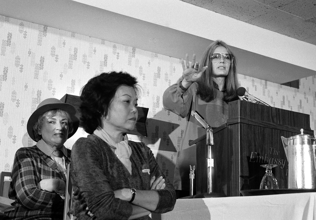 FILE - Bella Abzug, left, and Patsy Mink of Women USA sit next to Gloria Steinem as she speaks in Washington, Nov. 21, 1979. (AP Photo/Harvey Georges, File)