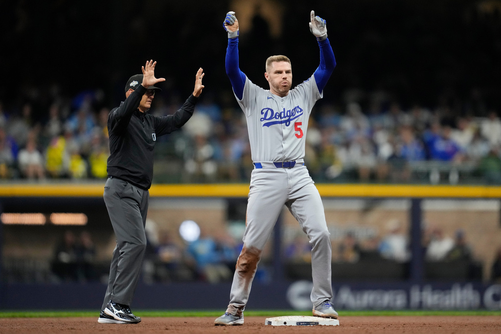 Los Angeles Dodgers' Freddie Freeman celebrates after a double against the Milwaukee Brewers during the ninth inning in Game 2 of baseball's National League Championship Series, Tuesday, Oct. 14, 2025, in Milwaukee. (AP Photo/Ashley Landis)