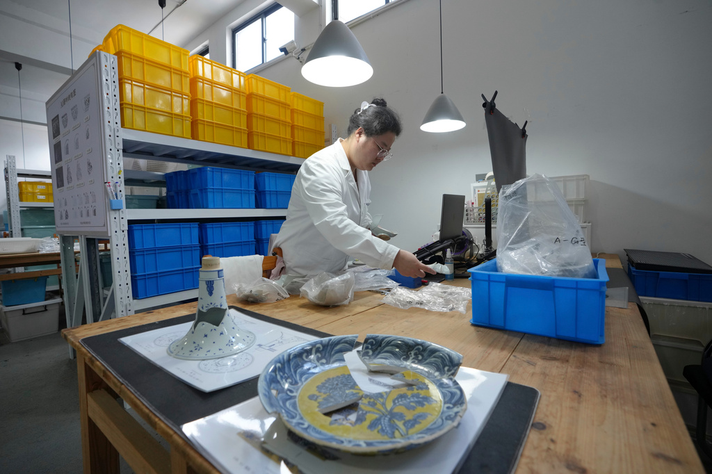 A researcher works at the Jingdezhen Imperial Kiln Institute which specializes in the research and restoration of ceramics excavated from the city's historic imperial kiln sites in Jingdezhen, in eastern China's Jiangxi province, Monday, Aug. 31, 2026. (AP Photo/Achmad Ibrahim)