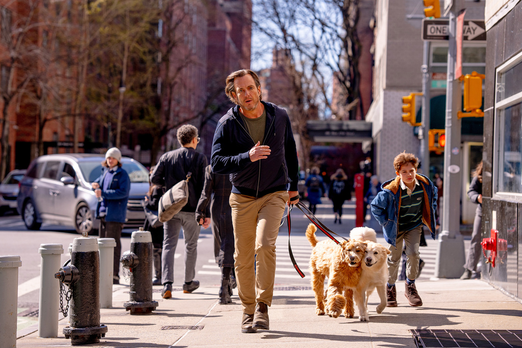 This image released by Searchlight Pictures shows Will Arnett, center, and Blake Kane, right, in a scene from "Is This Thing On?" (Jason McDonald/Searchlight Pictures via AP)