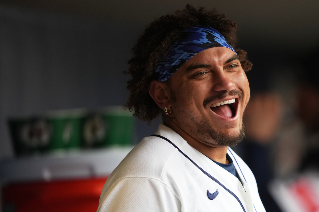 Seattle Mariners' Josh Naylor laughs in the dugout during the sixth inning of a baseball game against the Houston Astros, Monday, April 13, 2026, in Seattle. (AP Photo/Lindsey Wasson)