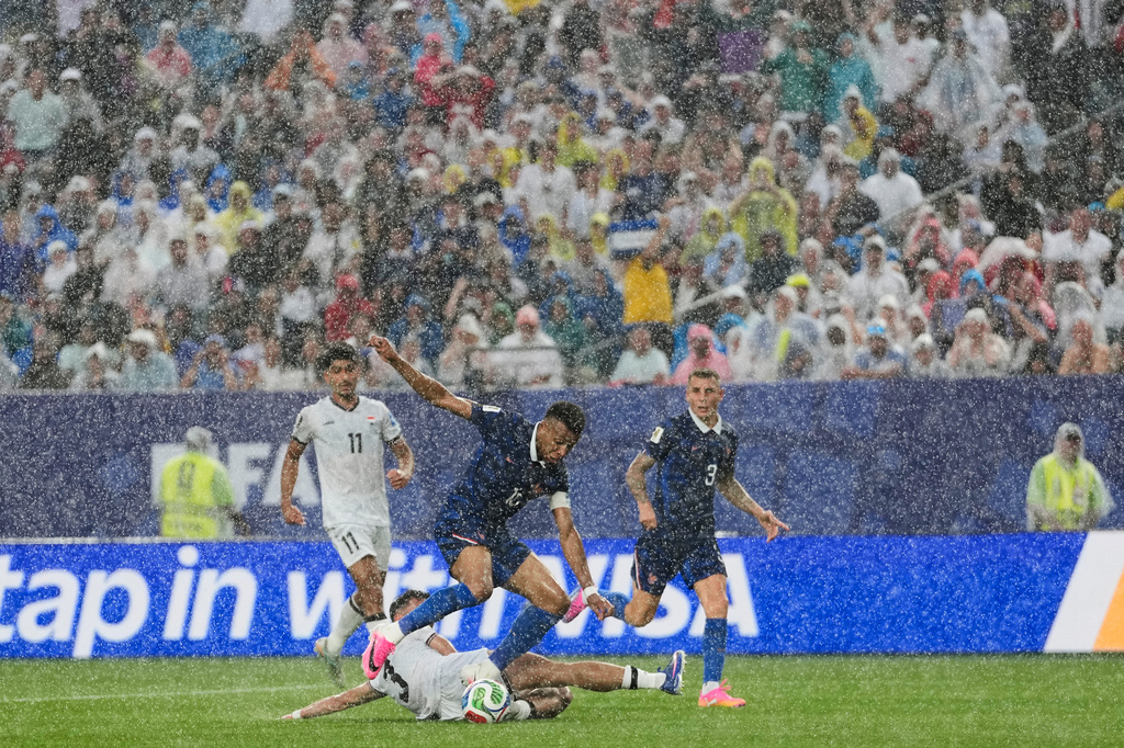 Iraq's Hussein Ali, bottom, challenges France's Kylian Mbappe during the World Cup Group I soccer match between France and Iraq in Philadelphia, Monday, June 22, 2026. (AP Photo/Matt Slocum)