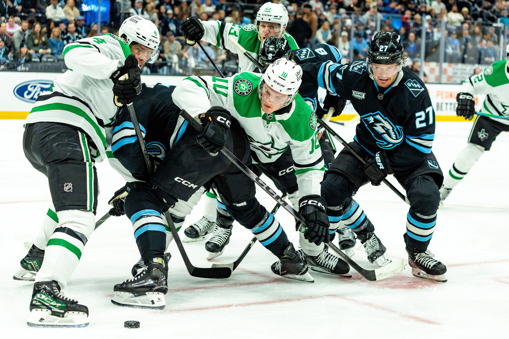 Dallas Stars players fight for the puck against Utah Mammoth players during the first period of an NHL hockey game Saturday, Jan. 31, 2026, in Salt Lake City. (AP Photo/Melissa Majchrzak)