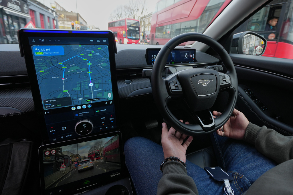 Britain Robotaxis Samir Mosawi, Demo Safety Operator, keeps his hands cupped around the steering wheel of the autonomous vehicles during a test drive in London, Monday, Feb. 9, 2026. (AP Photo/Kin Cheung)
