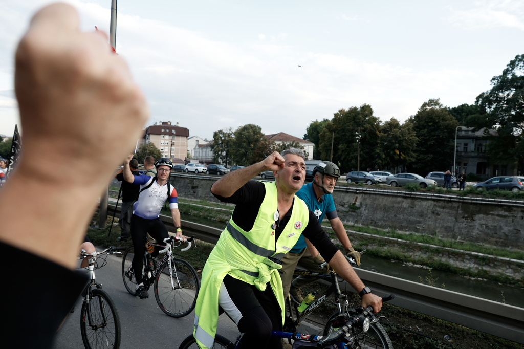 Ilija Srdanovic, cardiologist and professor at the Faculty of Medicine in Novi Sad, on top of the "Student list - Students win" in the upcoming parliamentary elections shouts slogans at the end of their cycling tour of the Balkan country, in Kragujevac, Serbia, Saturday, Sept. 26, 2026. (AP Photo/Marko Drobnjakovic)