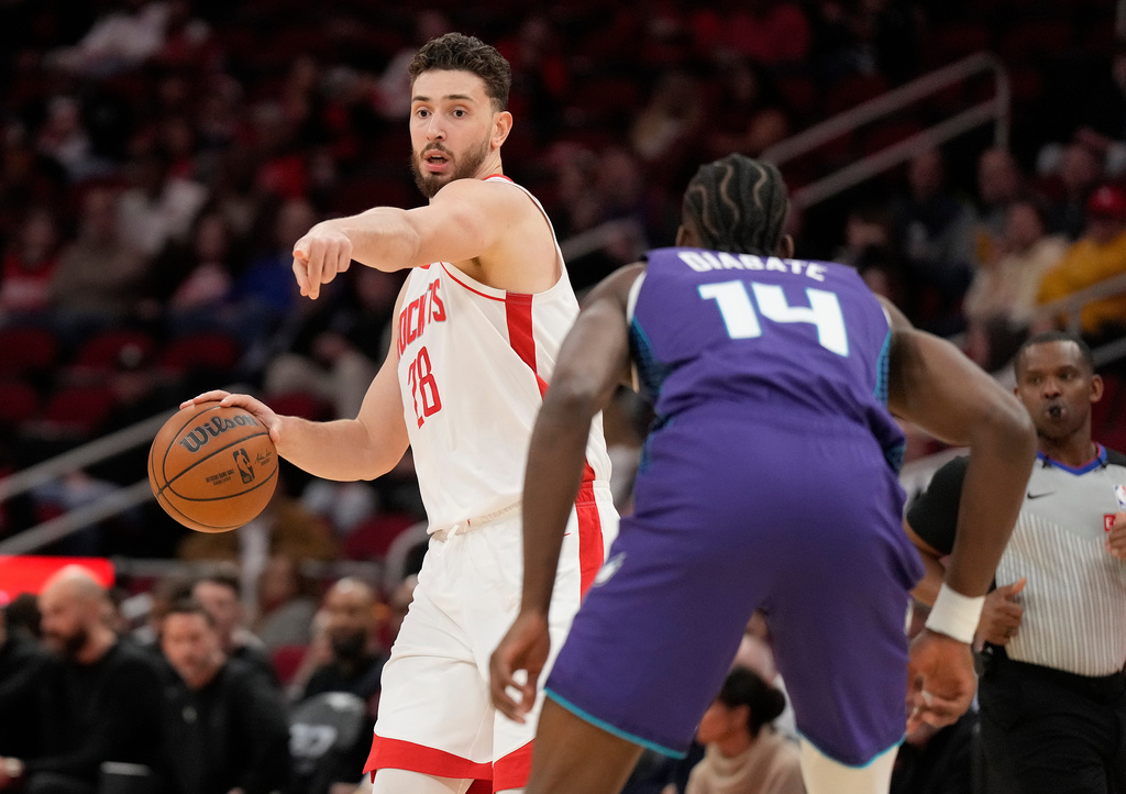 Houston Rockets center Alperen Sengun (28) looks to pass the ball against Charlotte Hornets forward Moussa Diabate (14) during the first half of an NBA basketball game, Thursday, Feb. 5, 2026, in Houston. (AP Photo/ Karen Warren)