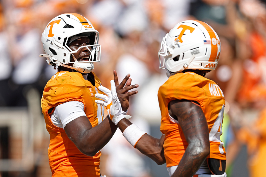 Tennessee quarterback Faizon Brandon (11) celebrates a touchdown with wide receiver Mike Matthews (4) during the first half of an NCAA college football game against Furman, Saturday, Sept. 5, 2026, in Knoxville, Tenn. (AP Photo/Wade Payne)